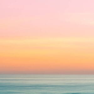 A pink and yellow sky over the ocean