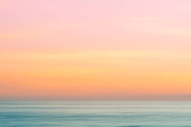 A pink and yellow sky over the ocean