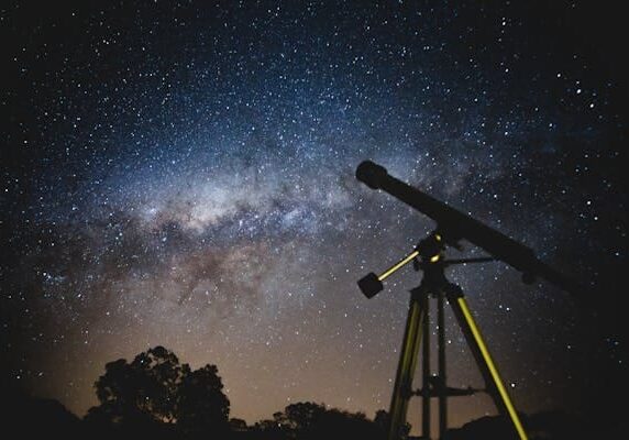 A telescope looking at the stars in the night sky.